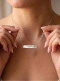 God Is Greater Than the Highs and Lows stainless steel bar necklace with cross cutout
