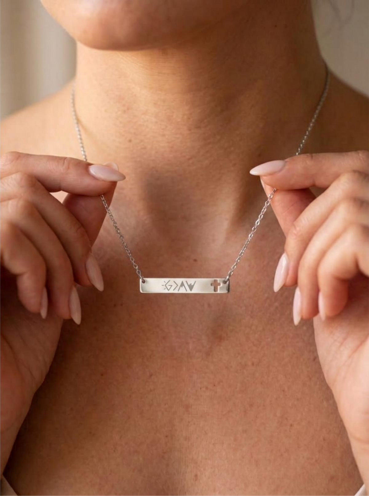 God Is Greater Than the Highs and Lows stainless steel bar necklace with cross cutout
